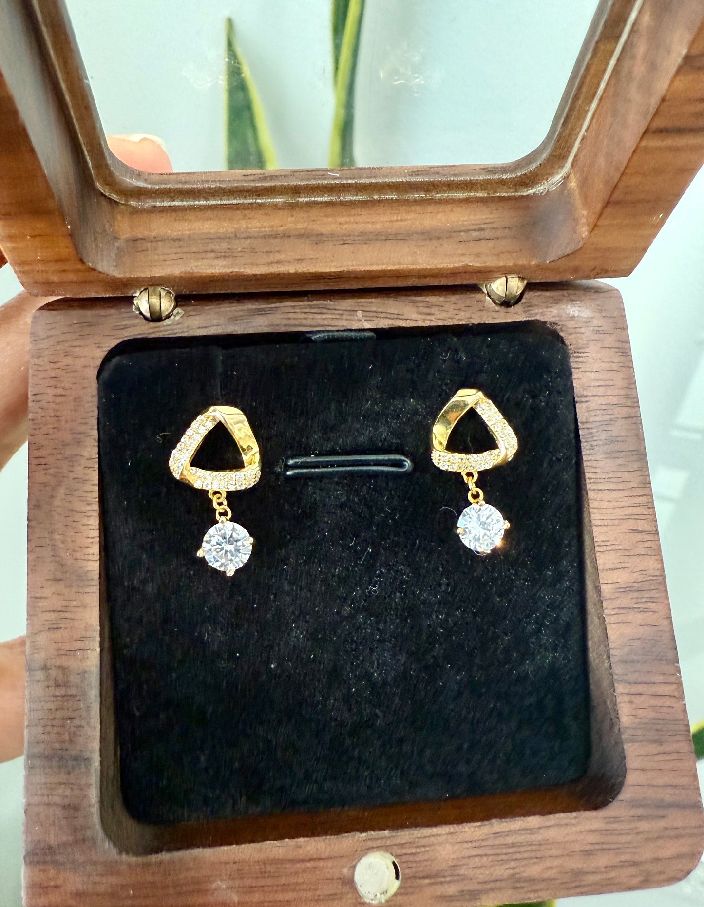 Triangle shaped studded earrings with hanging diamonds